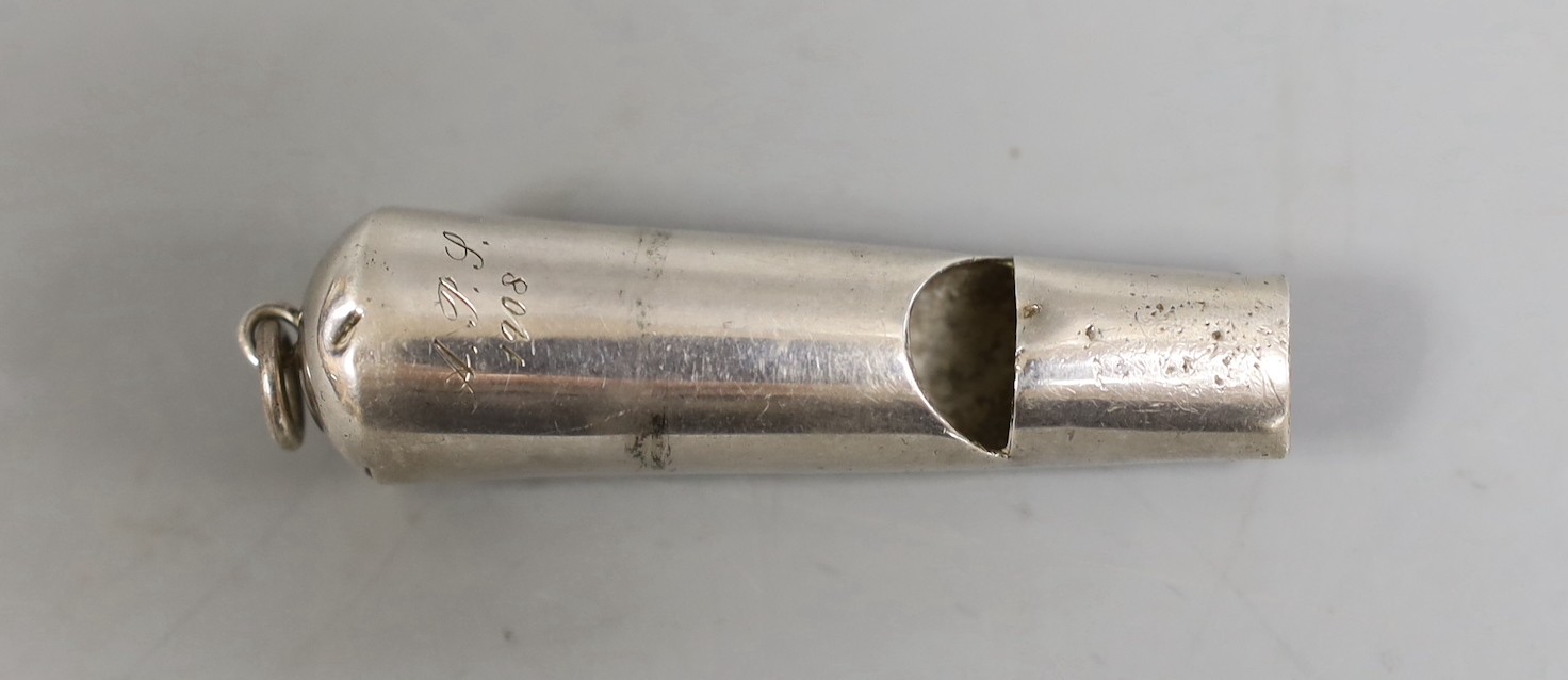 An early 20th century Chinese Export white metal whistle by Wang Hing, Hong Kong, 71mm.